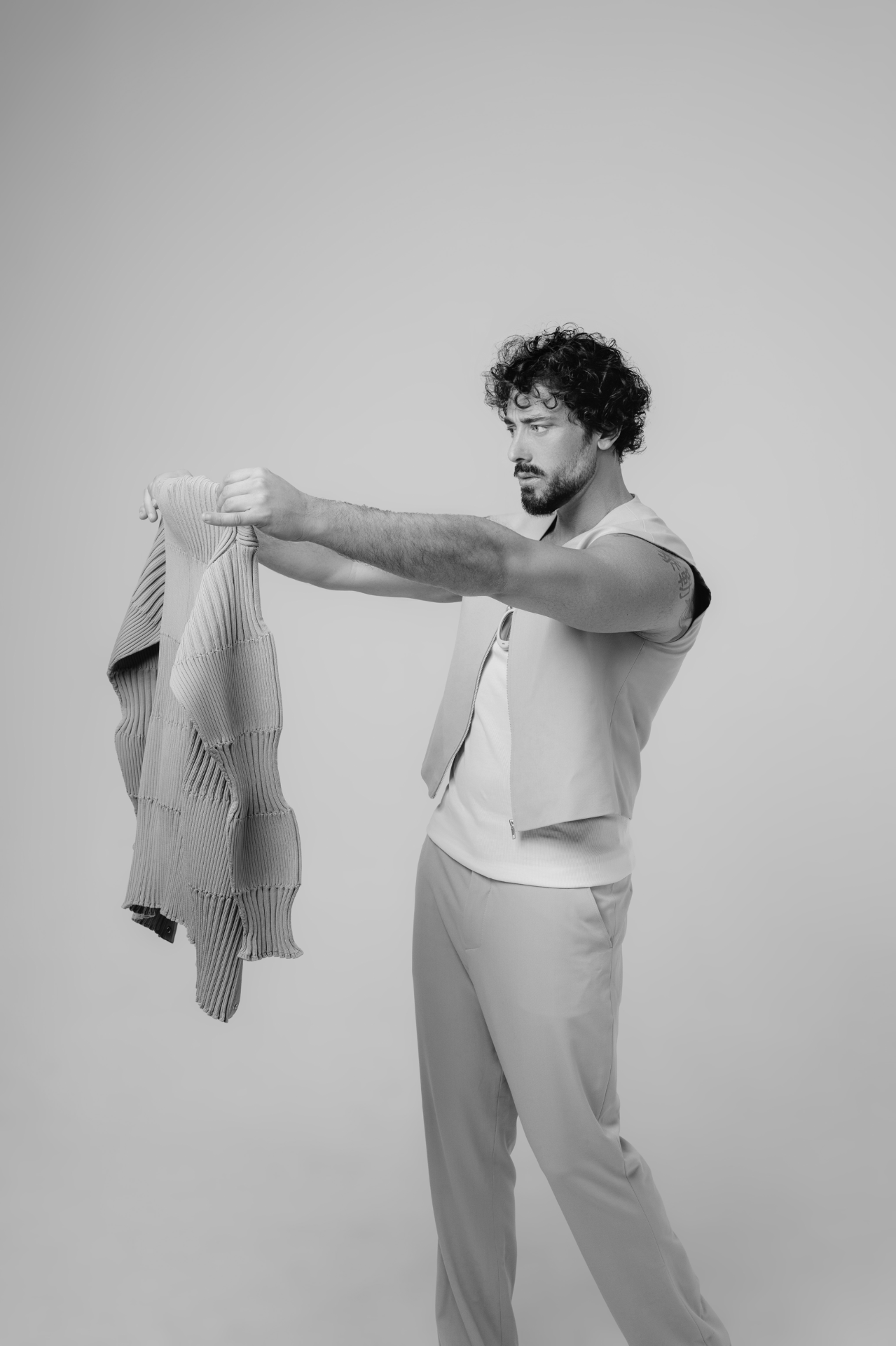 Examining a garment in studio